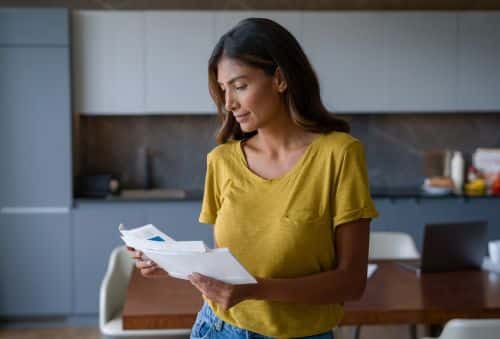 Woman at home checking the mail