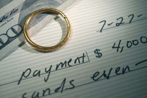 close up shot of alimony payment check - navigating spousal support concept