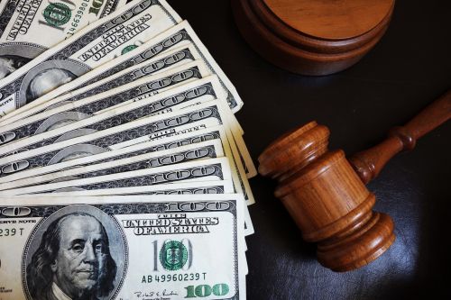 Legal court gavel on assorted cash - high income divorce concept