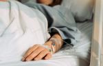 woman lying sick in hospital - child custody and parent health concept