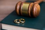 rings with judge on book on table - avoid divorce court concept