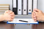 Hands of wife and husband signing divorce documents - annulment and divorce concept