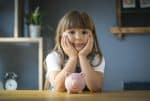 little girl with piggy bank