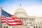 american flag flying in front of capitol building