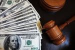 Legal court gavel on assorted cash - high income divorce concept