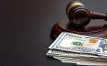 Judge's gavel with money on black table top - modifying spousal support concept
