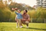 father spending time with son in the park - guideline to parenting time concept